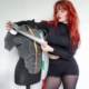 Madsfive standing next to a dress form with foam armor, holding duct tape and a measuring tape around the neck