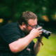 A man, Photosegi, holding a camera