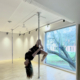 Photo of pole sport instructor doing a trick on the pole.